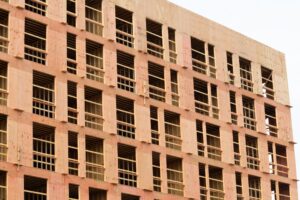 Building under construction with exposed brickwork and structural supports