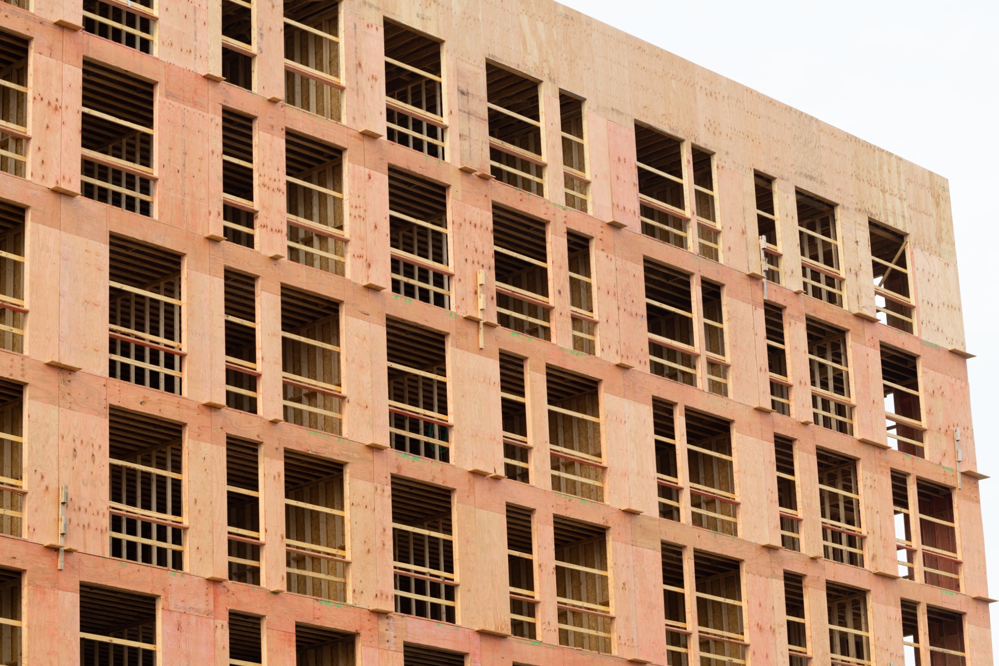 Building under construction with exposed brickwork and structural supports