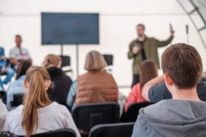 Audience listening to a presenter at a professional event
